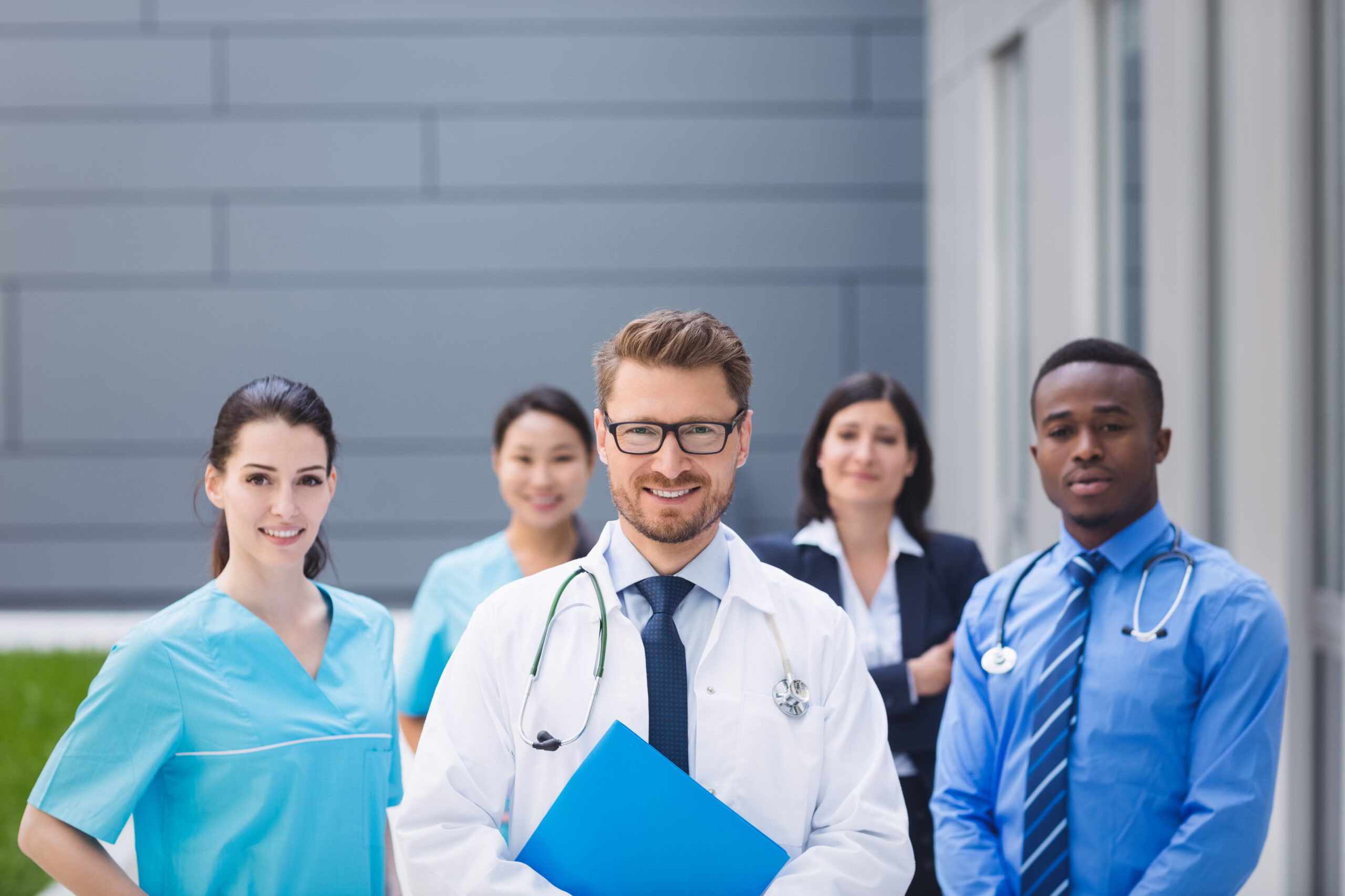 Portrait of smiling doctors standing together in hospital premises